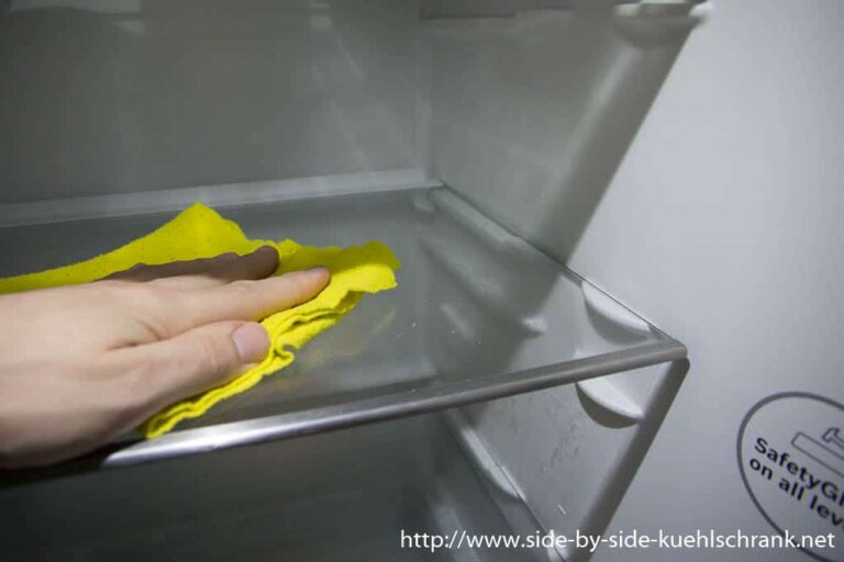 Reinigung eines Kühlschrank mit einem gelben Tuch.